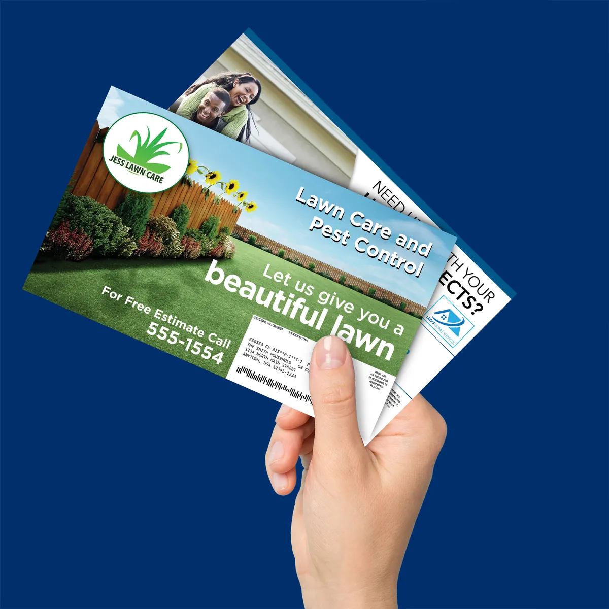 Hand holding Valpak postcards